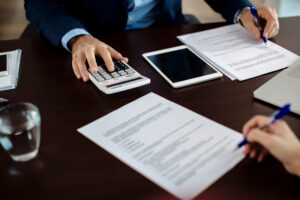 Closeup financial consult going through paperwork